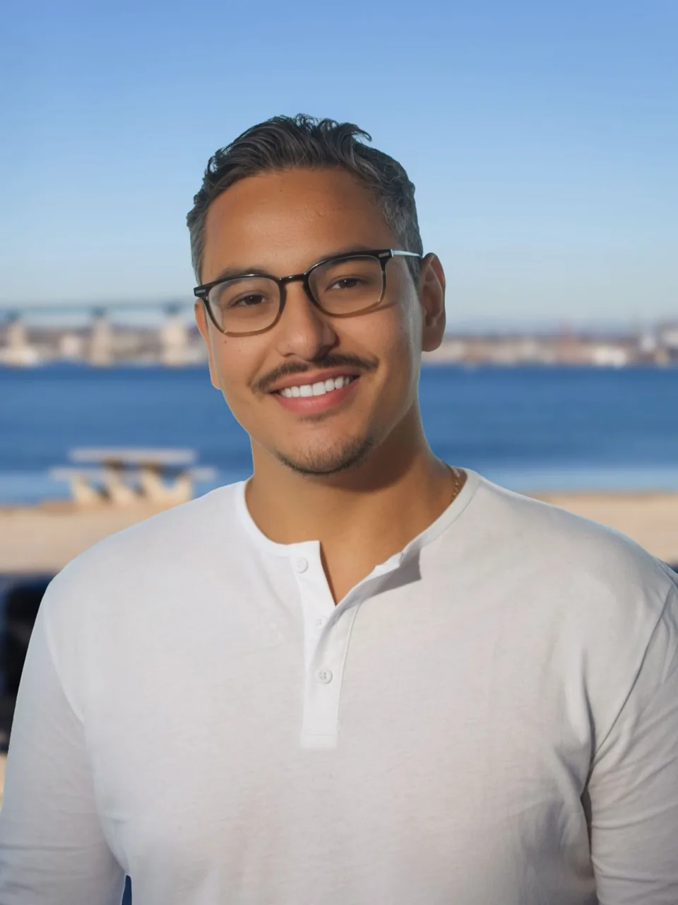 Danny Quesada, founder of Launch Social, photographed on San Diego bay with the Coronado bridge behind him