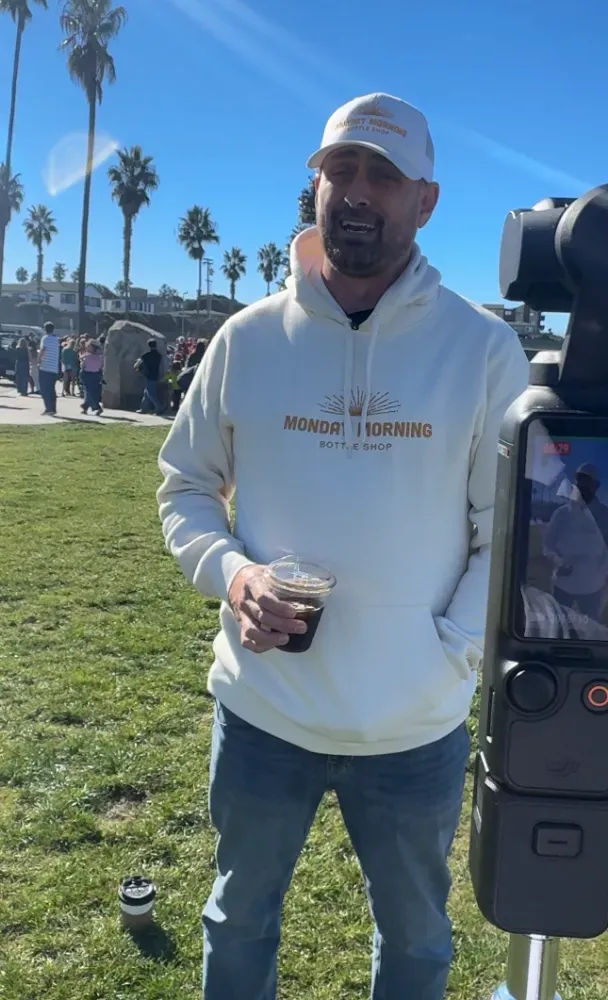 Zane Curtis being filmed on camera at a San Diego park event for Monday Morning